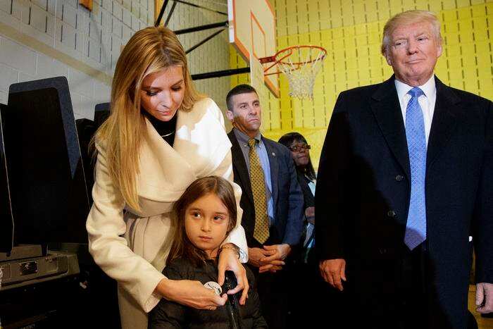 Republican presidential candidate Donald Trump watches as his daughter Ivanka puts an "I Voted" sticker on her daughter Arabella, after casting their ballots at PS-59, Tuesday, Nov. 8, 2016, in New York. (AP Photo/ Evan Vucci)