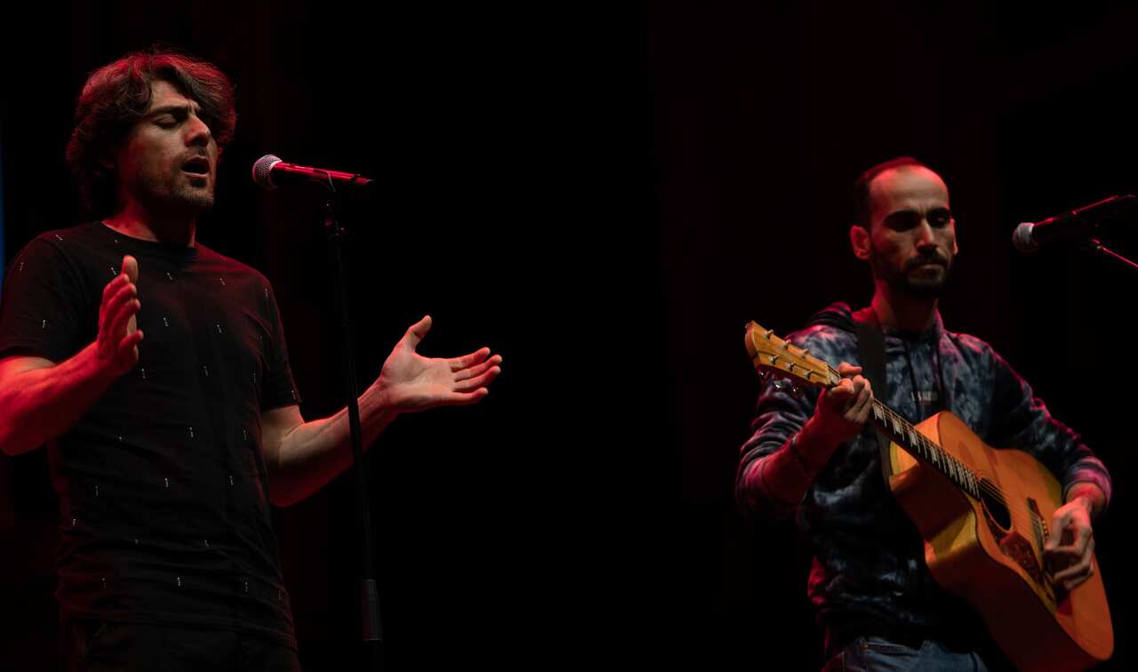 Kurdish Musicians and refugees Farhad Bandesh and Mostafa (Moz) Azimitabar on stage at Sydney Town Hall preforming a Kurdish song at Band Together on Refugee Week 2021.