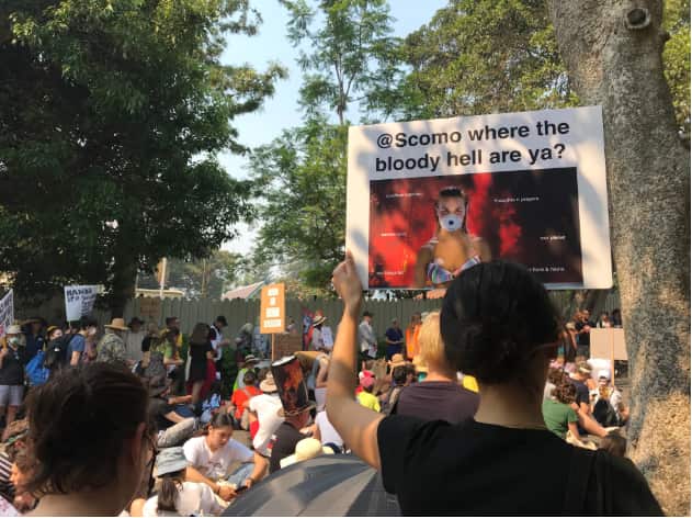 Protesters labelled the prime minister a "coward" for leaving the country while bushfires burned. SBS News