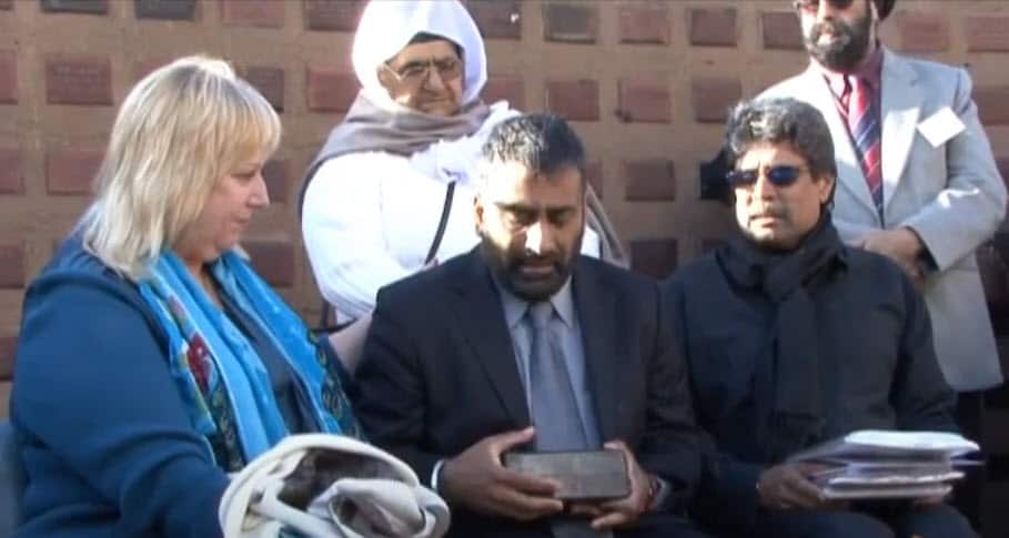 Harmel holding on to the box with his great Uncle's ashes, as Kapil Dev and Alice Guyett-Wood look on