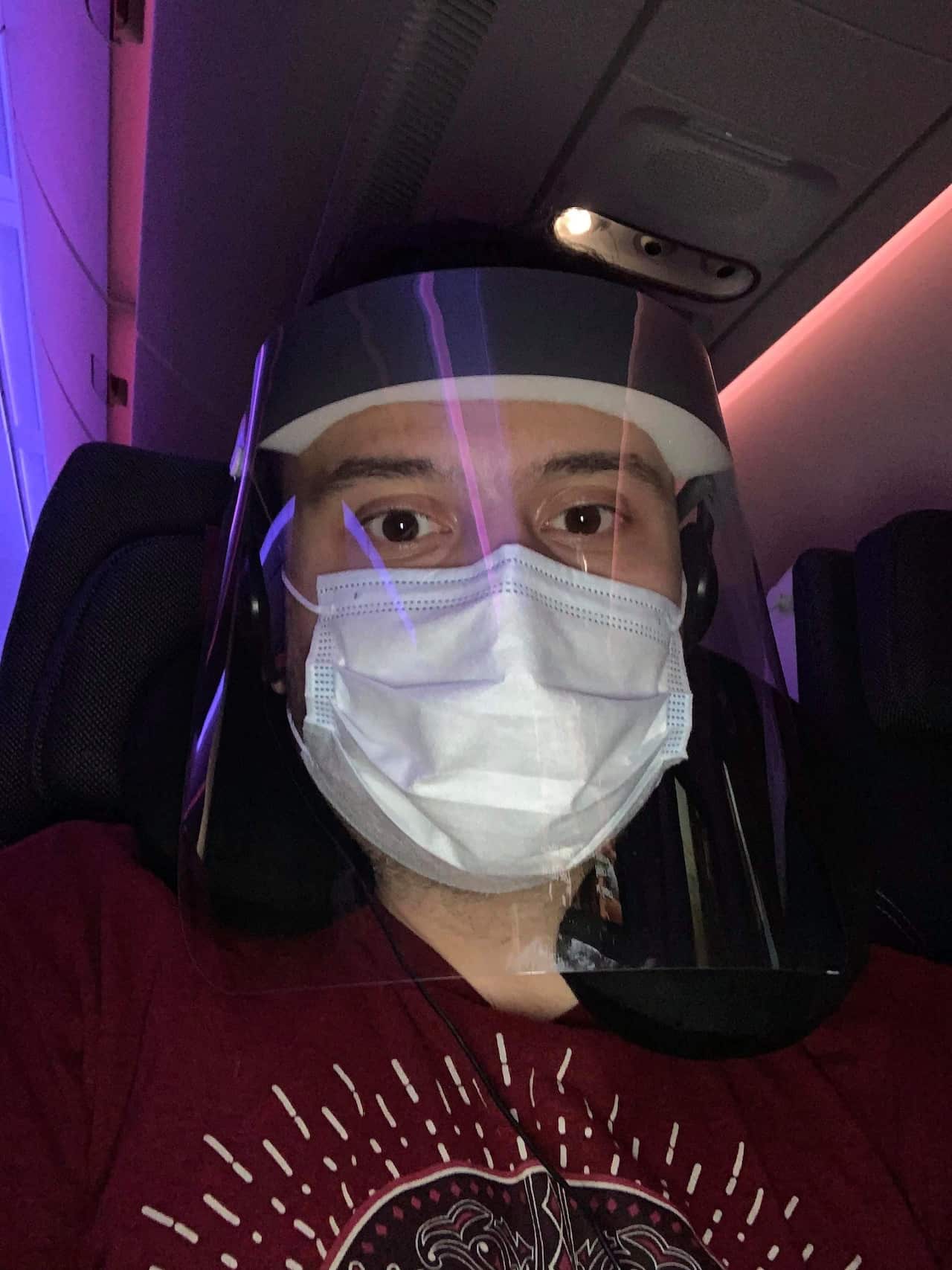 Mr Athanasiadis wearing face mask and cover during his Sydney-Athens flight