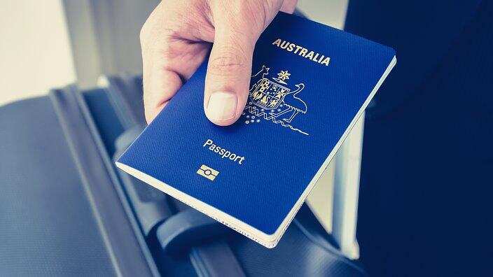 Hands giving Australian passport