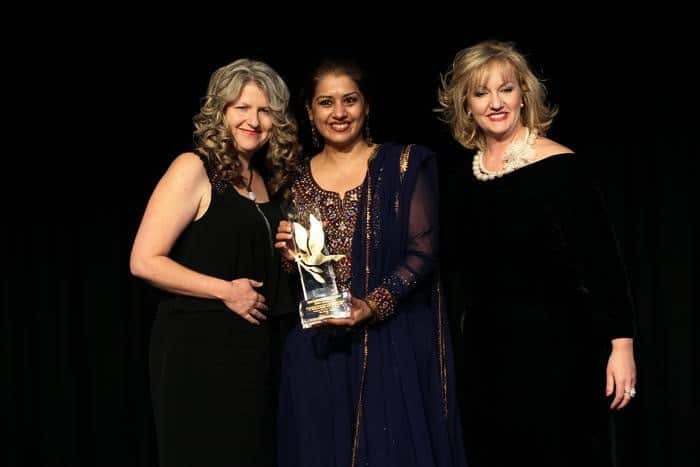 Manpreet receiving the UNAA award from Heidi Victoria, MP