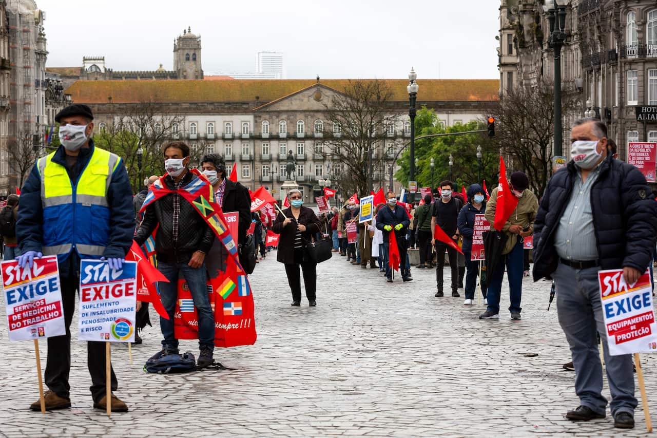 People protesting at a social distance from each other as a precaution against COVID-19 in Porto, Portugal.