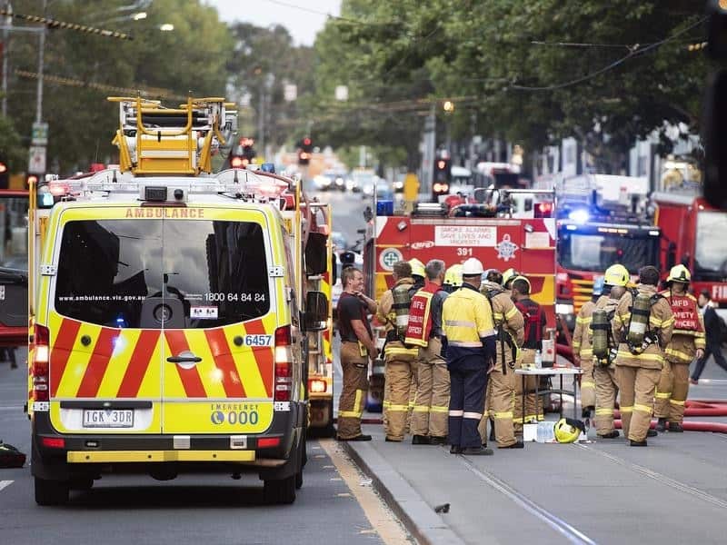 Firefighters are seen at the scene of an apartment building fire