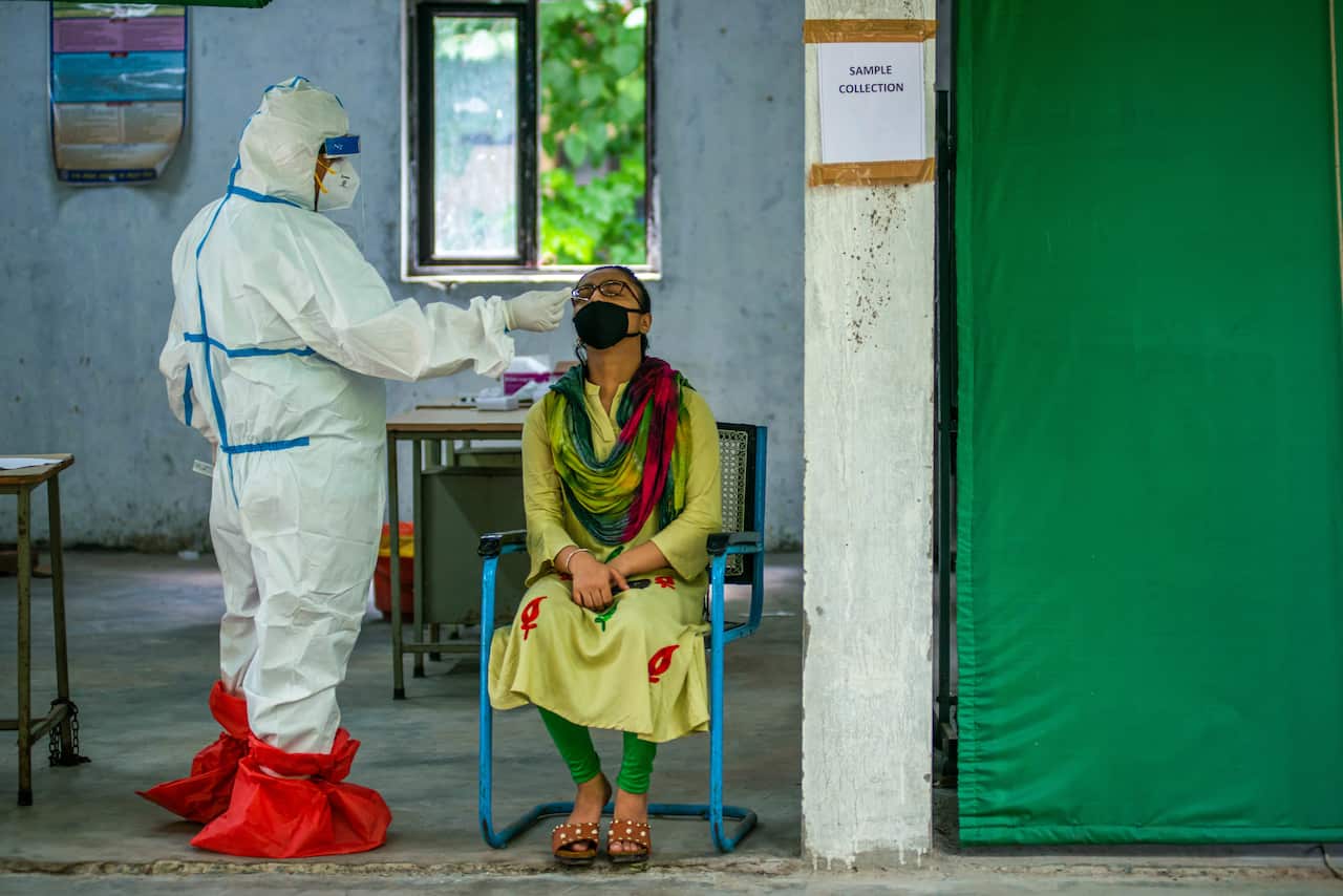 A health official in India tests for Covid 19. The Indian Government has planned to conduct rapid antigen COVID-19 tests in Delhi at 169 new facilities.
