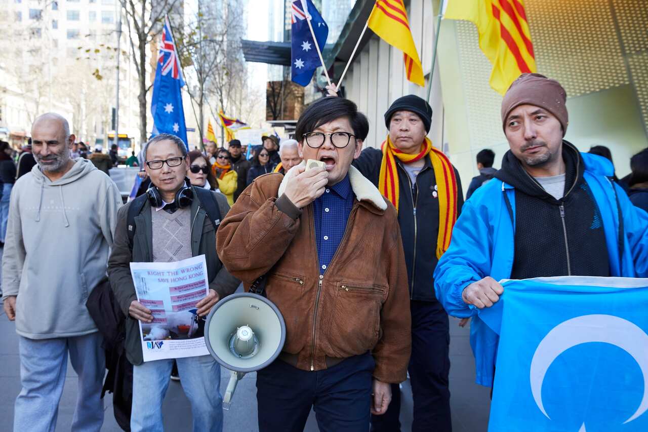 Pro-democracy demonstrators march during a rally supporting the Hong Kong democracy movement at the Victorian State Library in Melbourne.