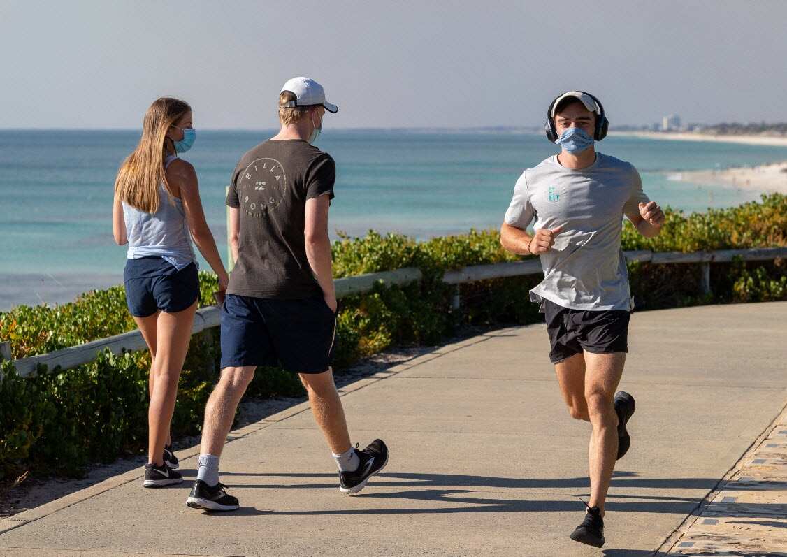 Members of the public exercise wearing masks along the foreshore at Cottesloe beach in Perth, Monday, 1 February, 2021. 