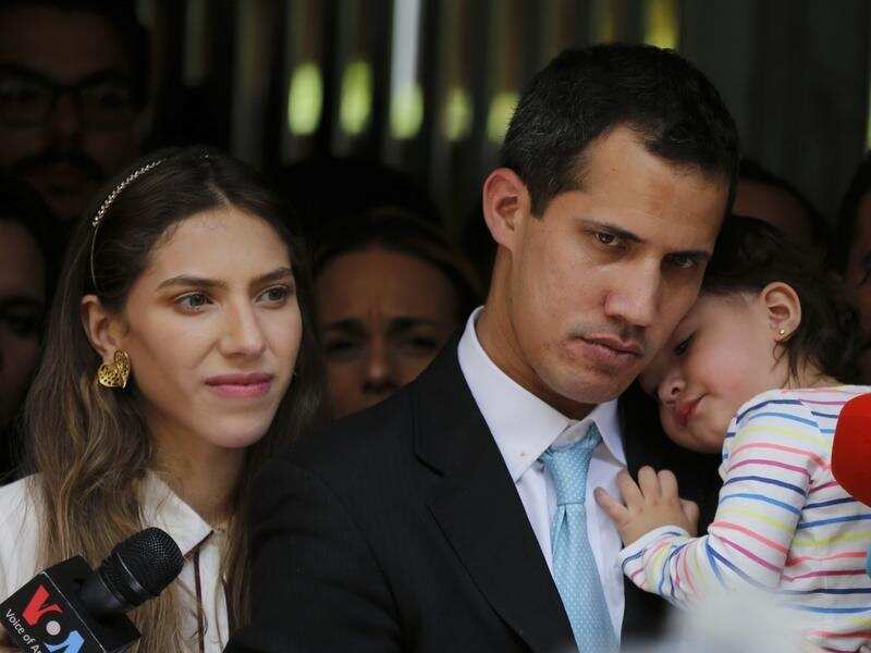 Juan Guaido (C) with wife Fabiana Rosales and baby Miranda
