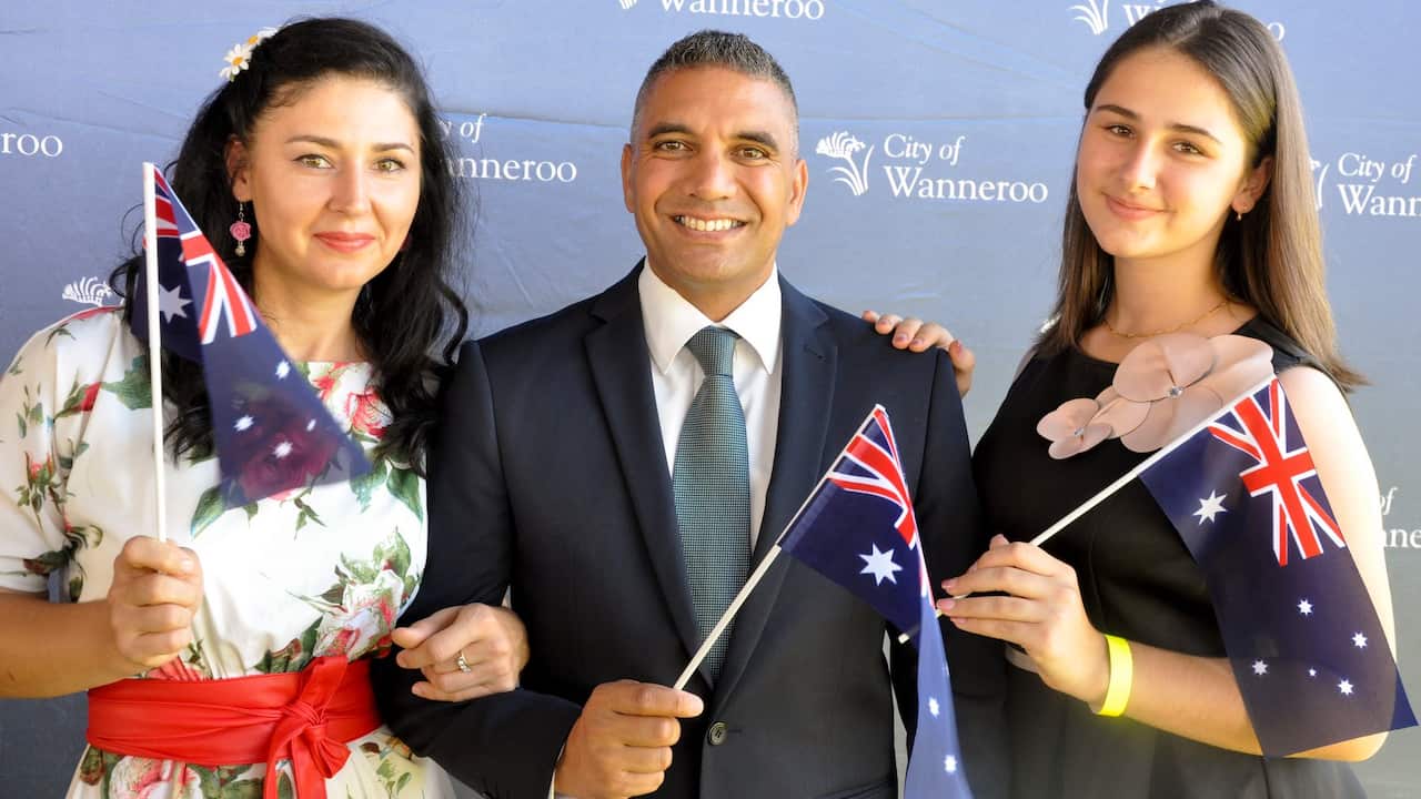 Zaira Alieva, Michael Edwards and Amina Khugaeva pose for a photograph during the City of Wanneroo citizenship ceremony, in Perth.
