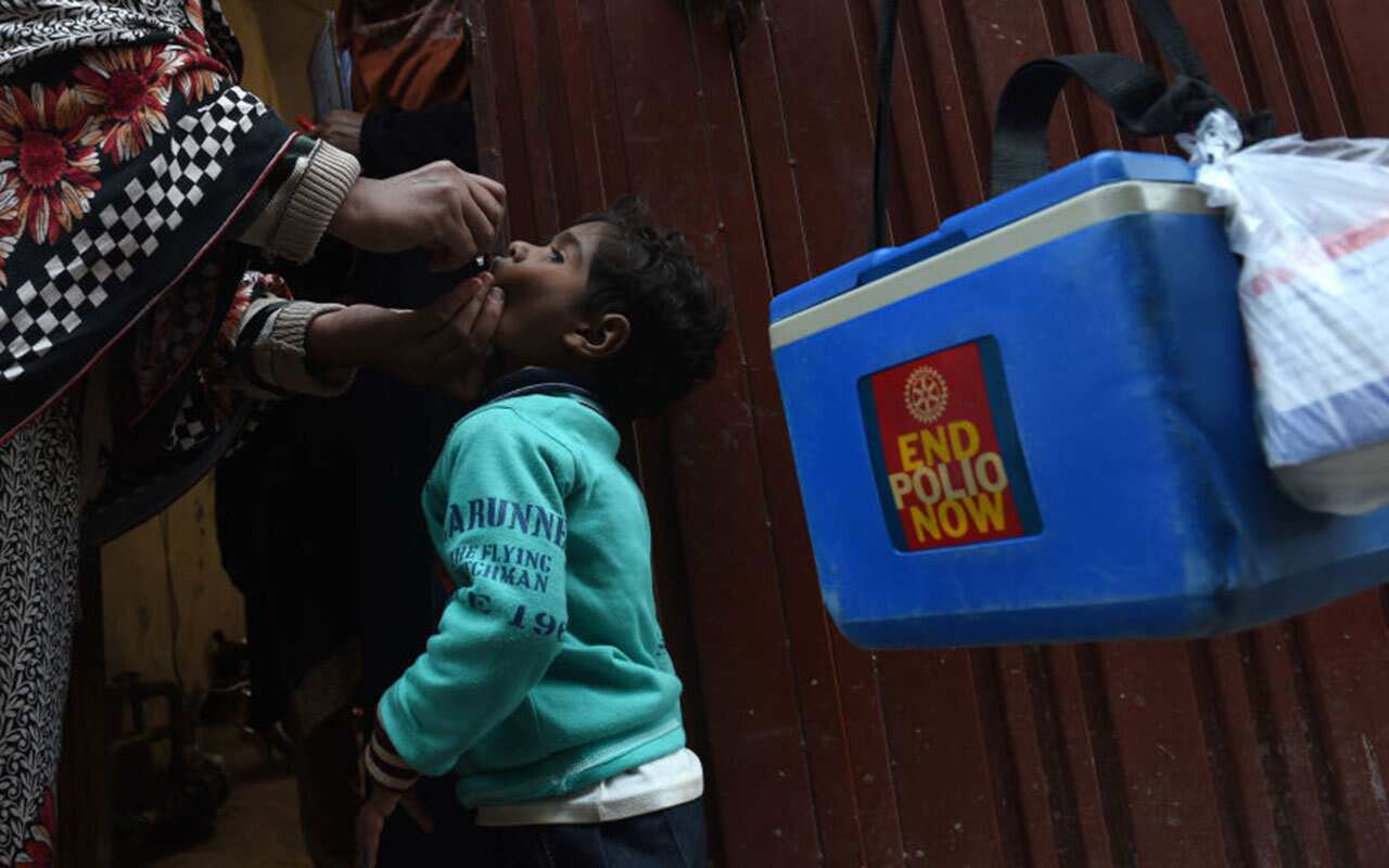 A Pakistani health worker administers polio vaccine drops to a child during a polio campaign in Lahore on January 15, 2018.
