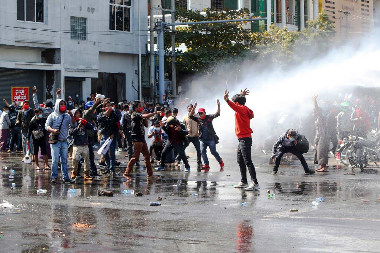Police use water-cannon to disperse demonstrators during a protest in Mandalay, Myanmar.