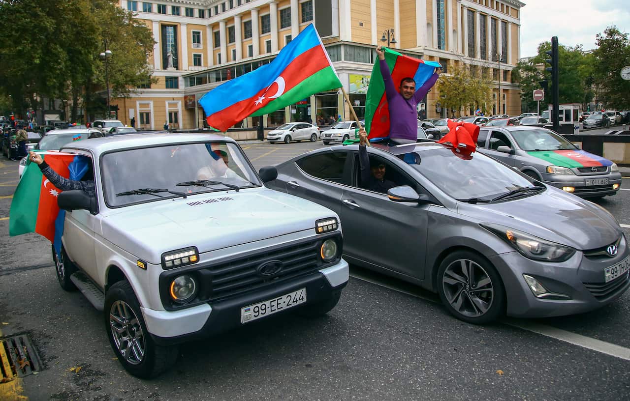 Azeri people celebrate the claimed recapture of the city of Shusha by Azerbaijani troops.