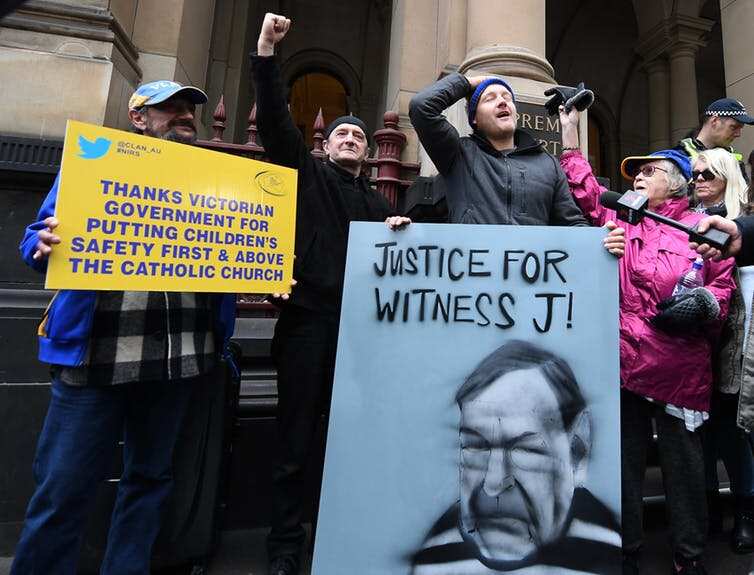 Supporters of abuse victims outside the Victoria Supreme Court building in August. Today’s decision was handed down in a near-empty High Court building.  