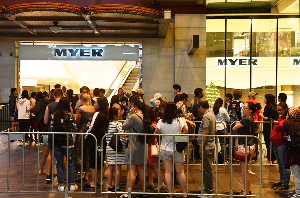 Shoppers wait outside the Myer department store for the Boxing Day sales in Sydney, 