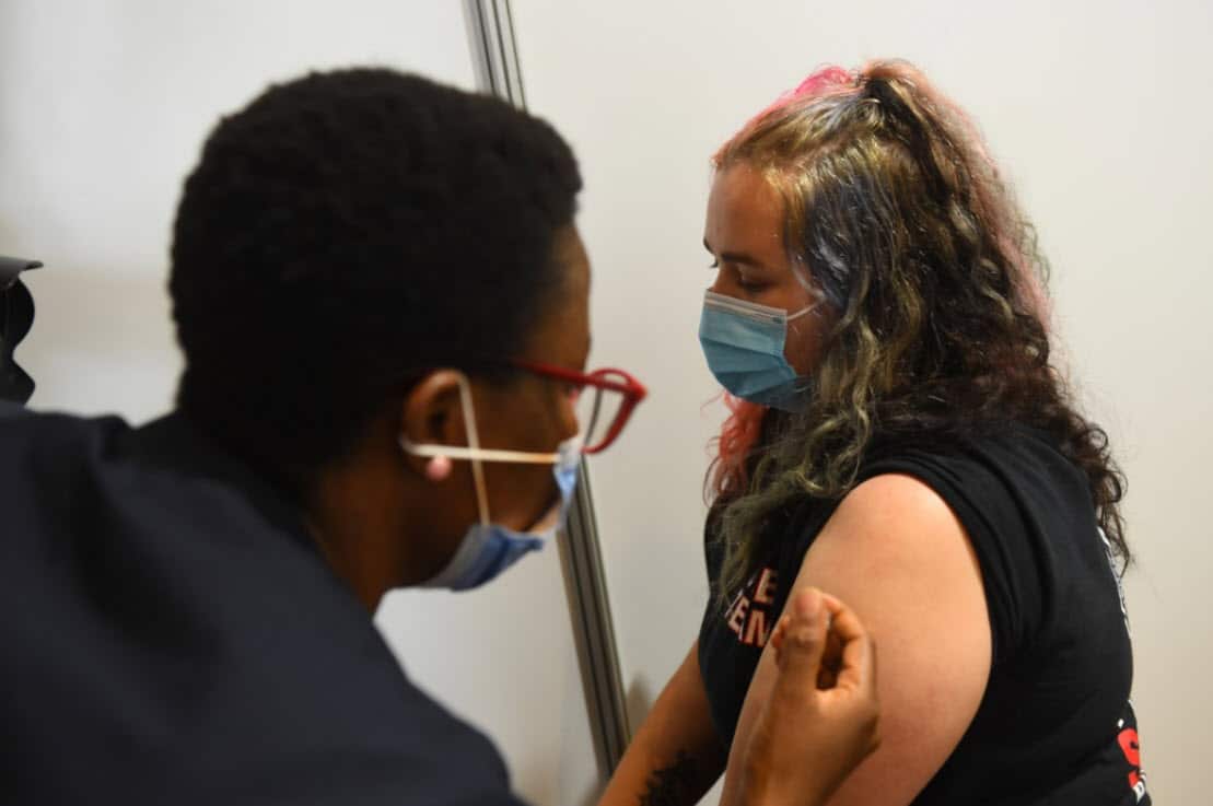 A woman receives an AstraZeneca vaccination at the Royal Exhibition Centre in Melbourne, Monday, March 22, 2021