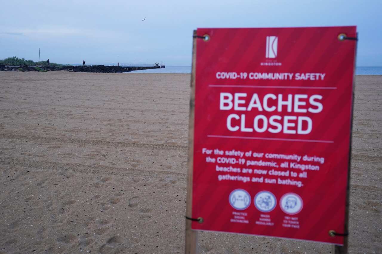 A closure sign is seen on Mordialloc beach at sunrise in Melbourne.