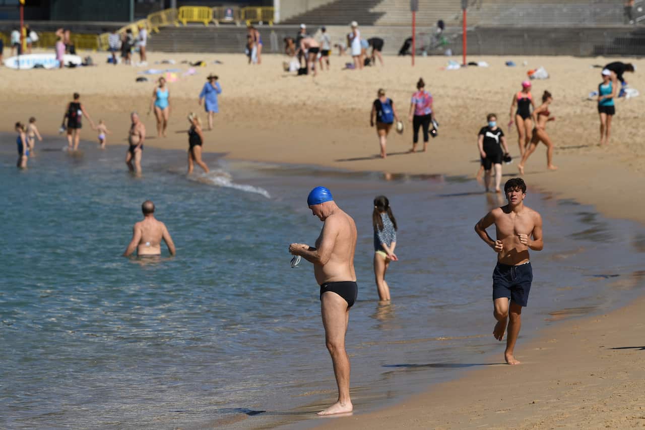 Beachgoers swimming and exercising on the sand at Coogee Beach last week.