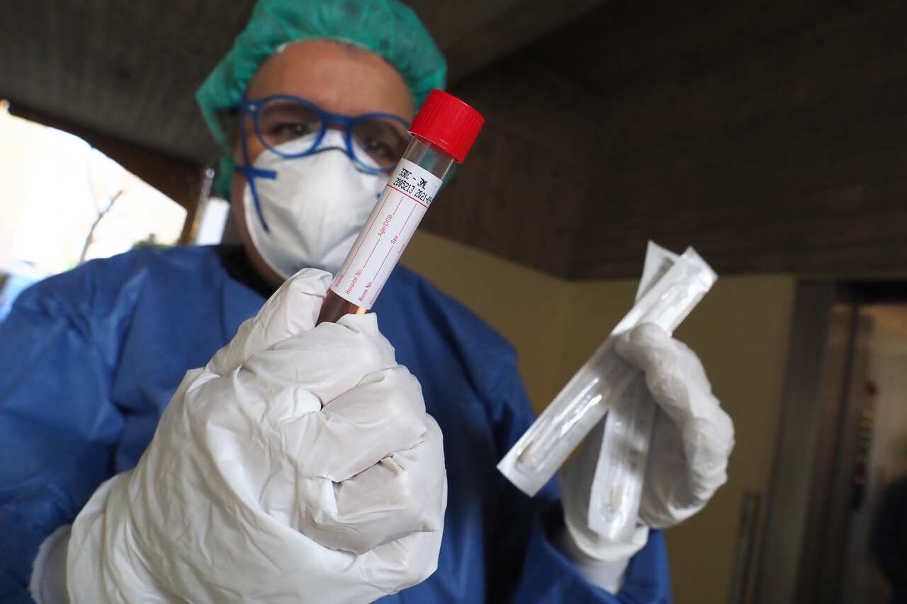 An Italian doctors collects a coronavirus test swab in Bologna, Italy.