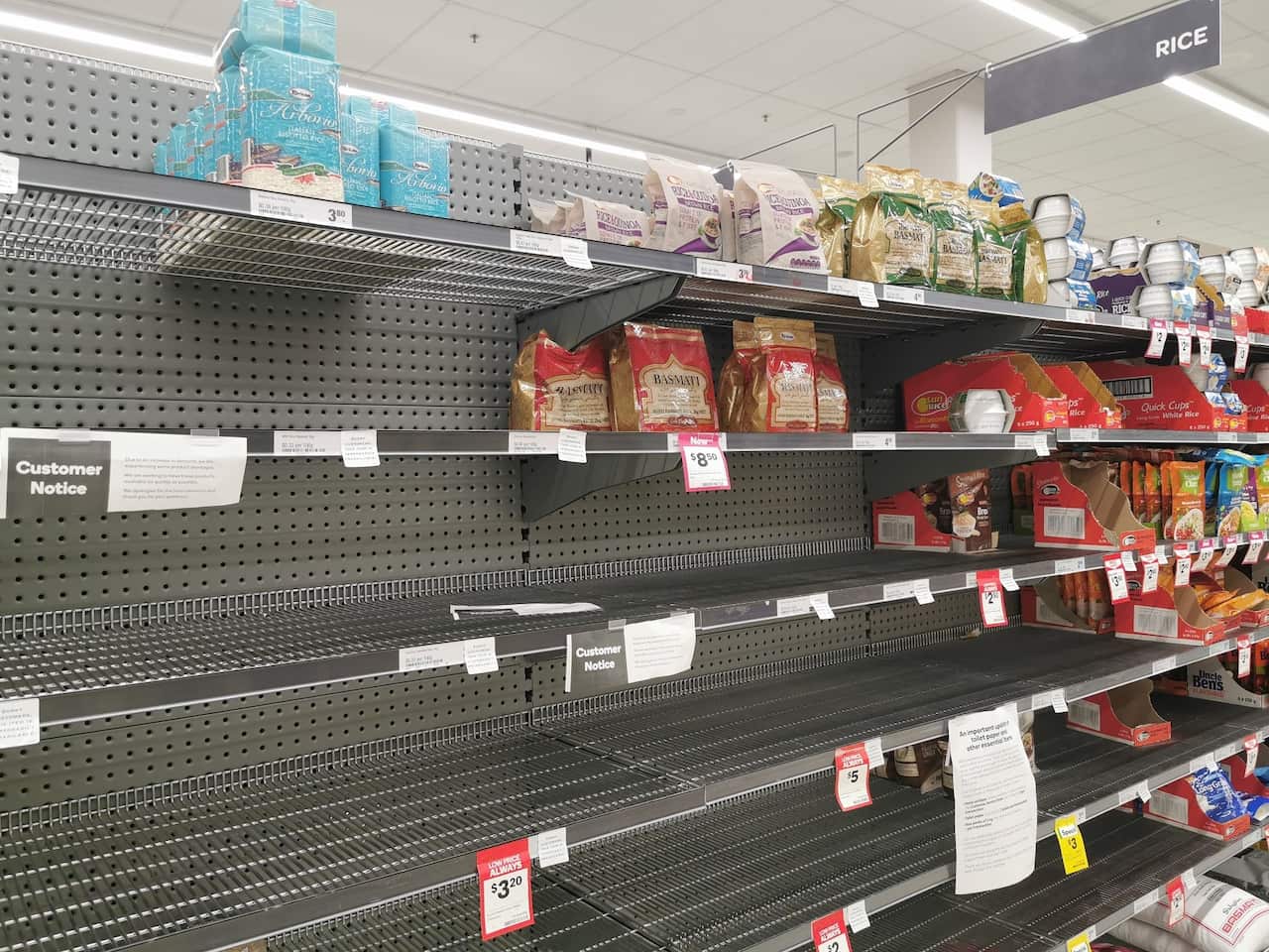 Empty rice and food aisles shelves at a supermarket in Brisbane.