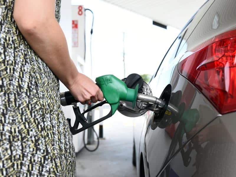 A motorist refuels her car at a service station 