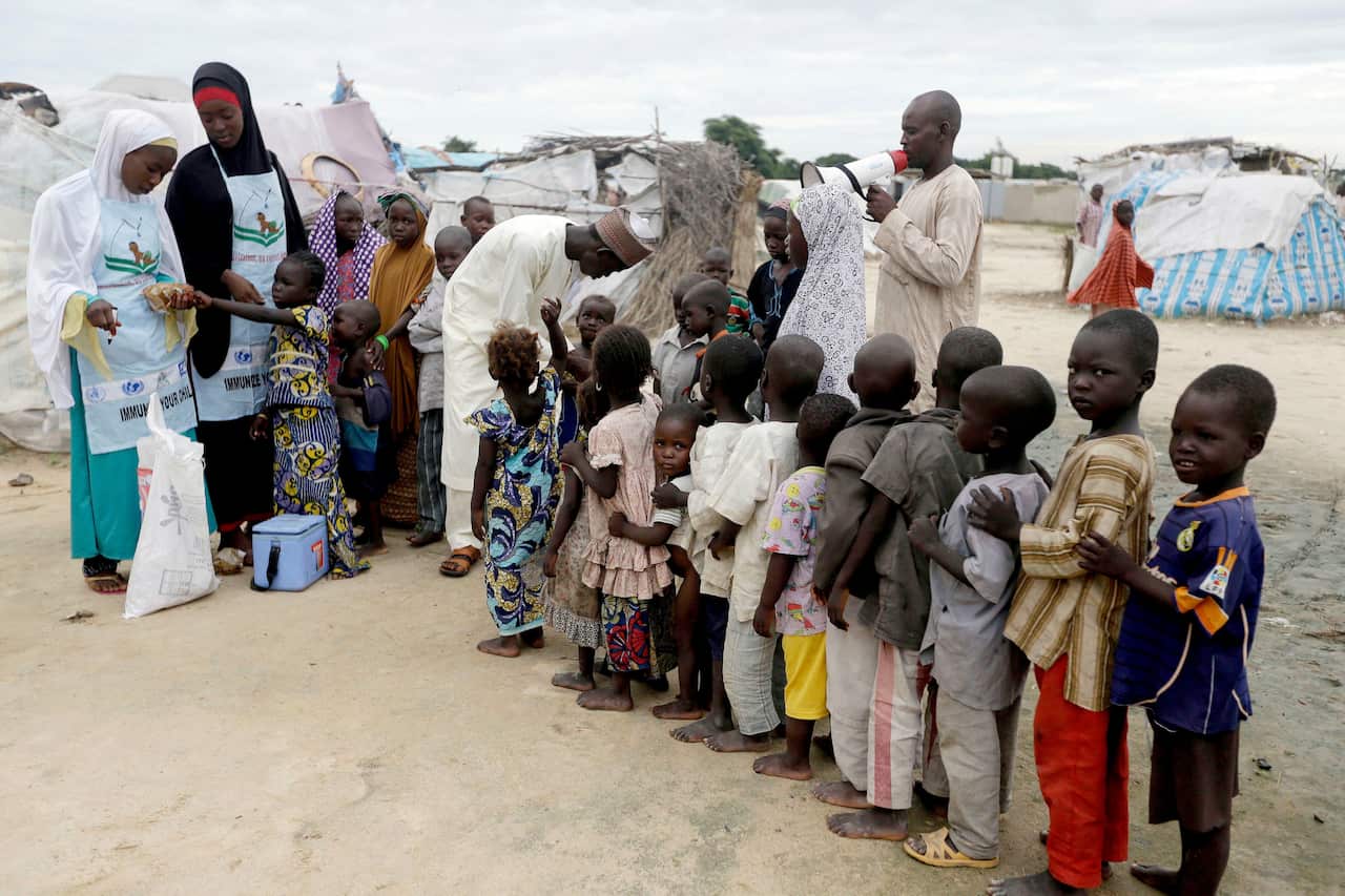 A file photo of health officials administering polio vaccine to children at a camp for people displaced by Islamist extremists in Maiduguri, Nigeria. 
