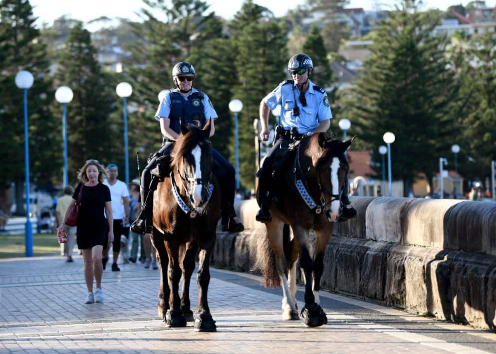 Mounted police patrol a closed Coogee Beach in Sydney.