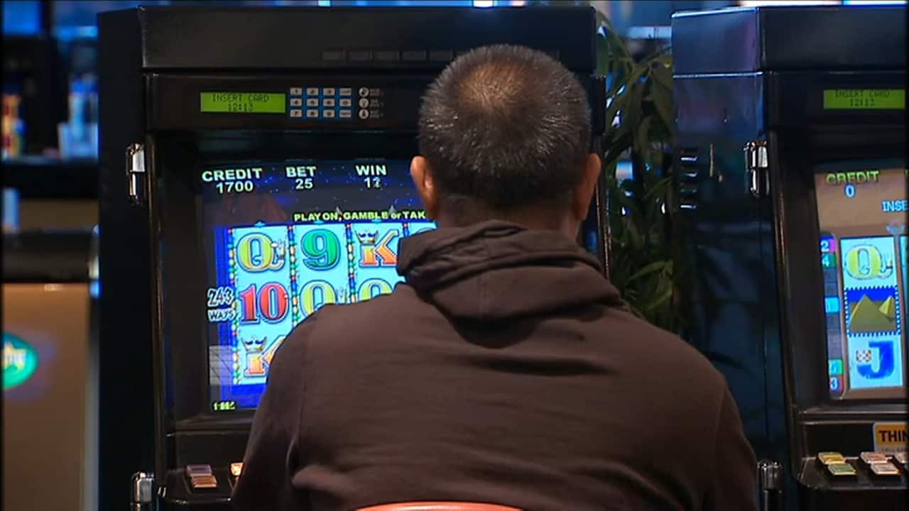 A man playing a poker machine