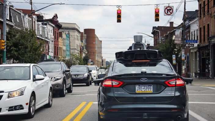 A self driving Uber car drives on Liberty Ave. through the Bloomfield neighborhood of Pittsburgh.