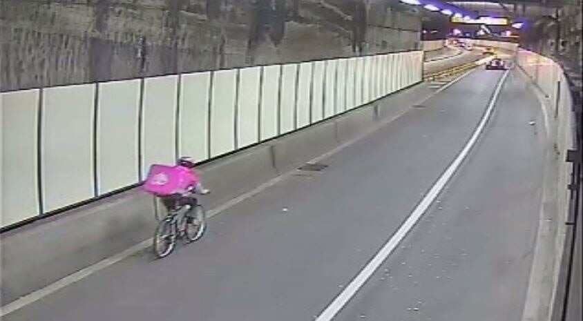 A food delivery cyclist in the tunnel where speeds can reach 80km/h.