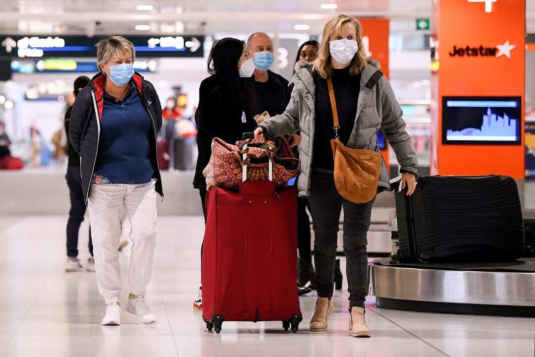 Passenger wearing masks are at Melbourne airport.