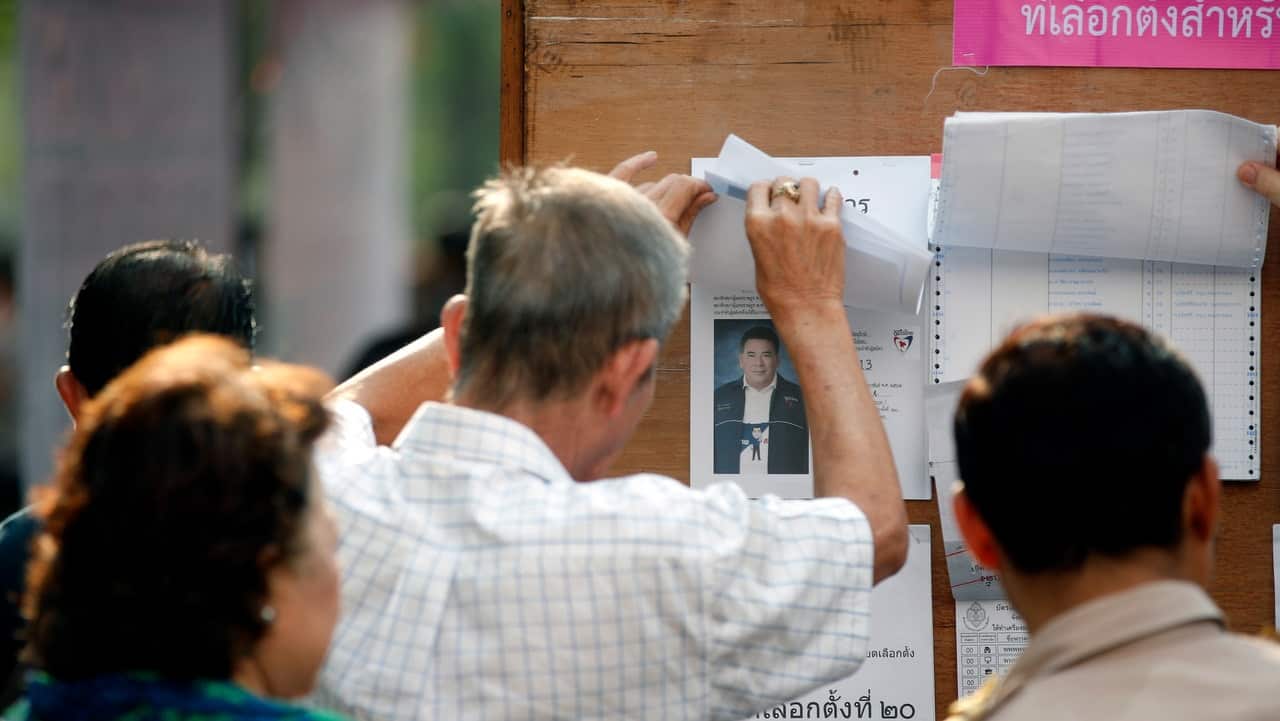 Thai citizens prepare to vote at a polling station during the general election on the outskirts of Bangkok.