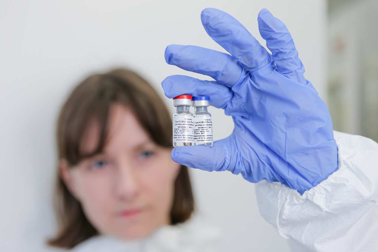 An employee shows a new vaccine at the Nikolai Gamaleya National Center of Epidemiology and Microbiology in Moscow, Russia.