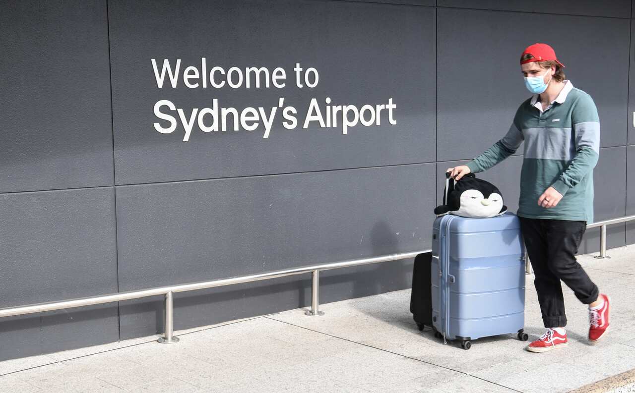  A passenger wearing a facemask outside the International Terminal at Kingsford Smith Airport.