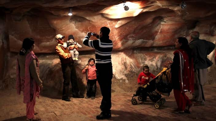 A Pakistani family take pictures while visiting the tourist area at the Khewra salt mine in Khewra,some 160 kms southeast of Islamabad, Khewra mines.
