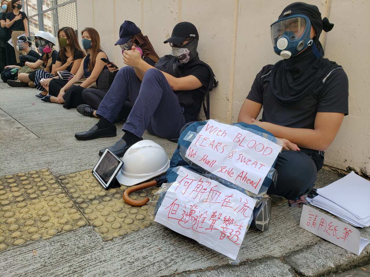 Hundreds of Hong Kongers staged a sit-in on Wednesday outside the school of a protester who was shot by police