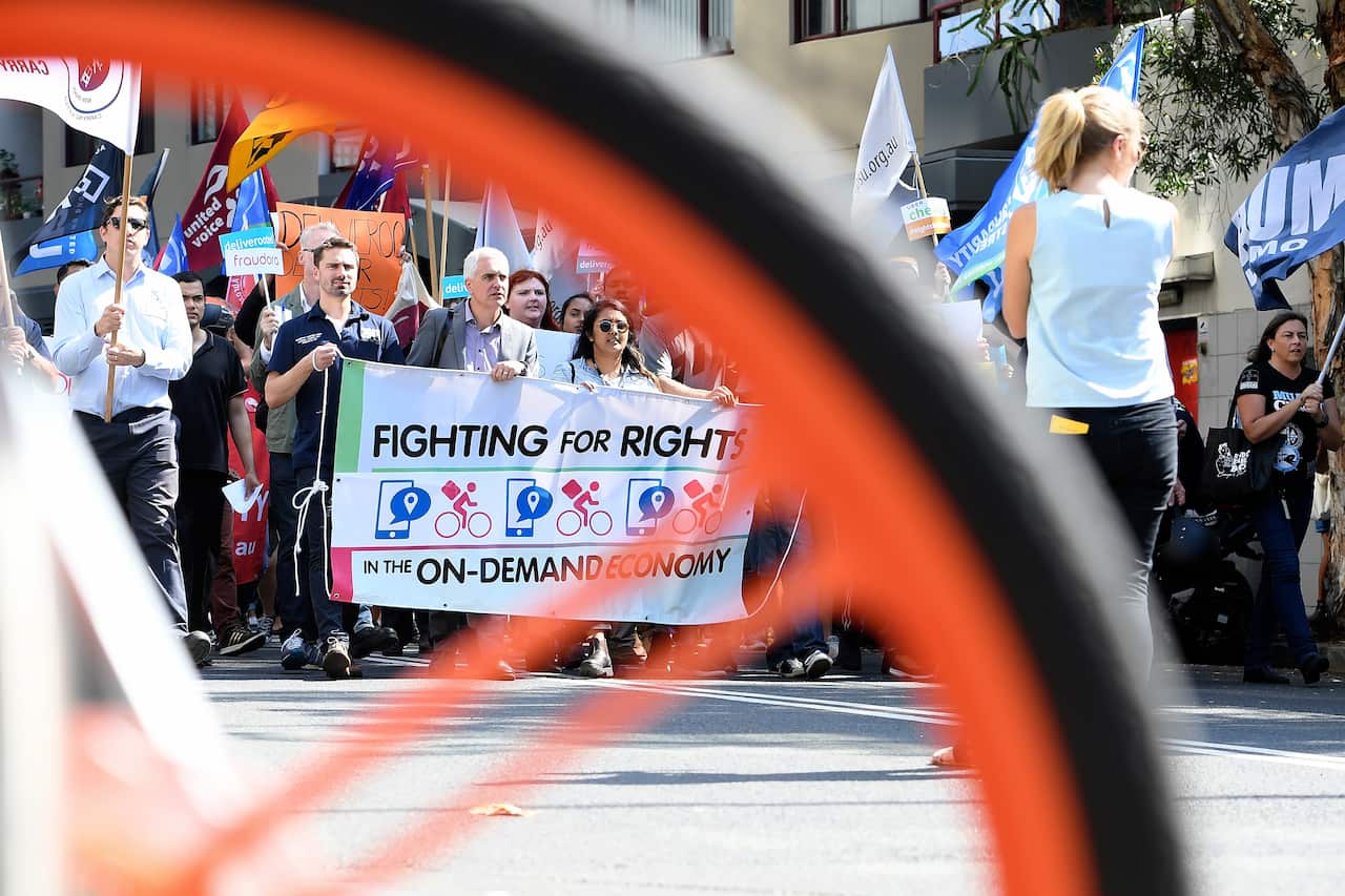 Protesters rally in support of food delivery riders in Sydney.