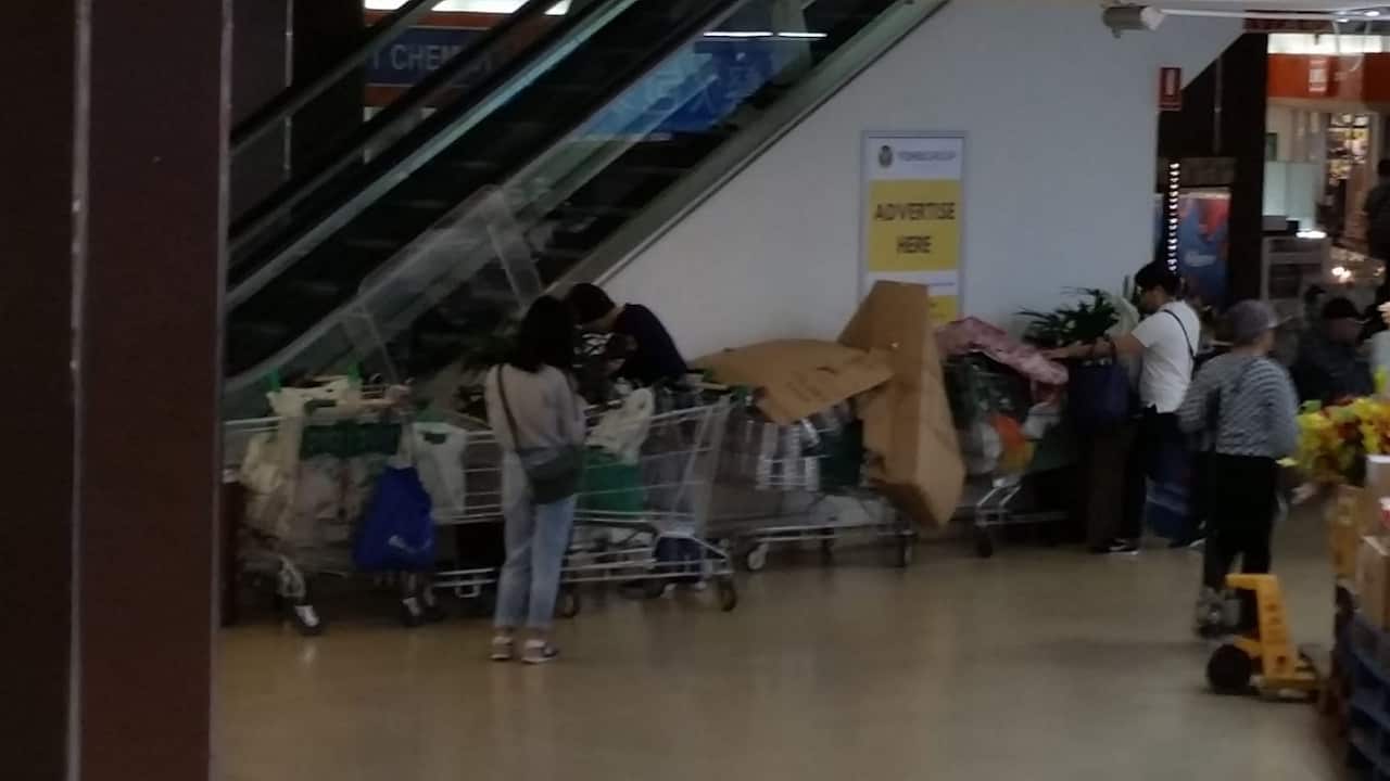 Trolleys full of baby formulas outside the supermarket.