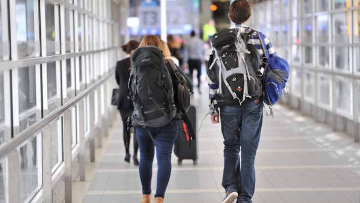 Backpackers make their way to the international terminal at Melbourne Airport in Melbourne, Wednesday, April 23, 2014. (AAP Image/Julian Smith) NO ARCHIVING