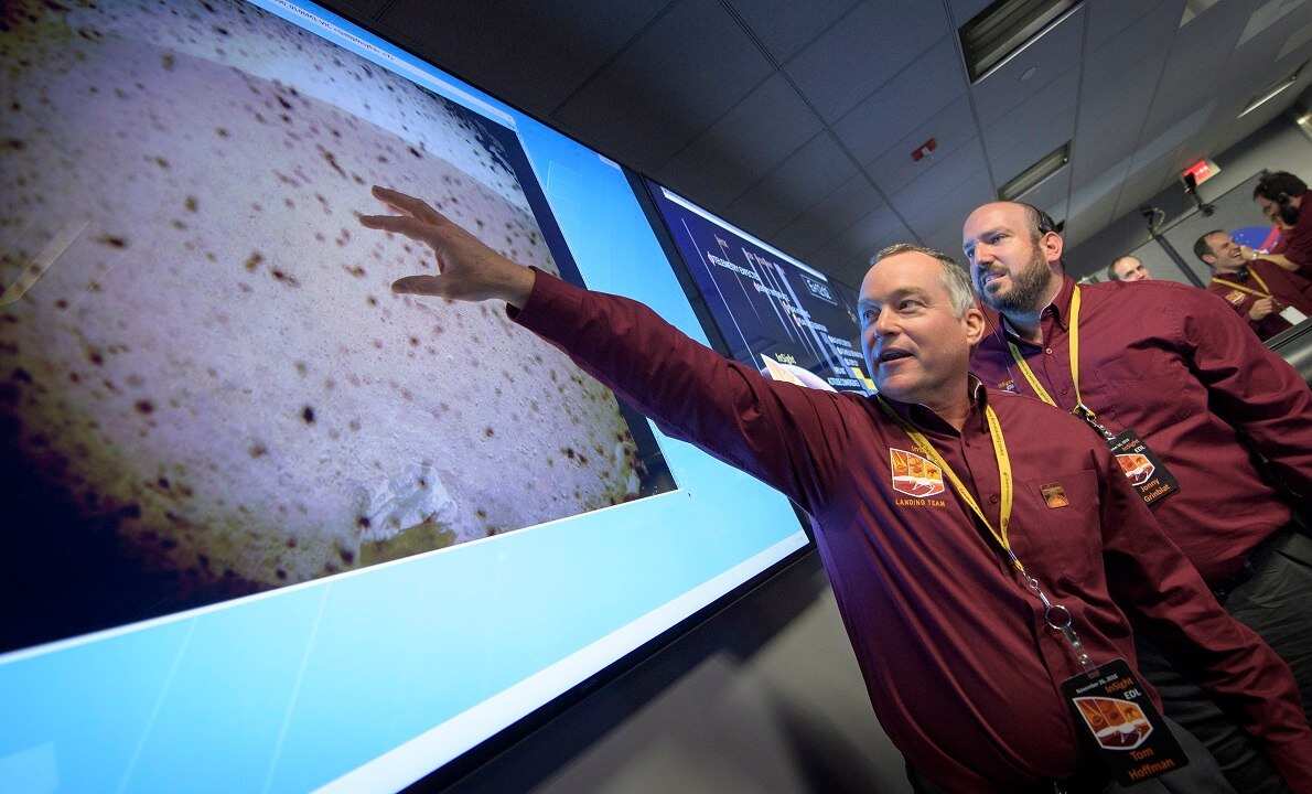 NASA's Tom Hoffman, InSight Project Manager, with the first image of Mars surface shortly after confirmation of a successful touch down.