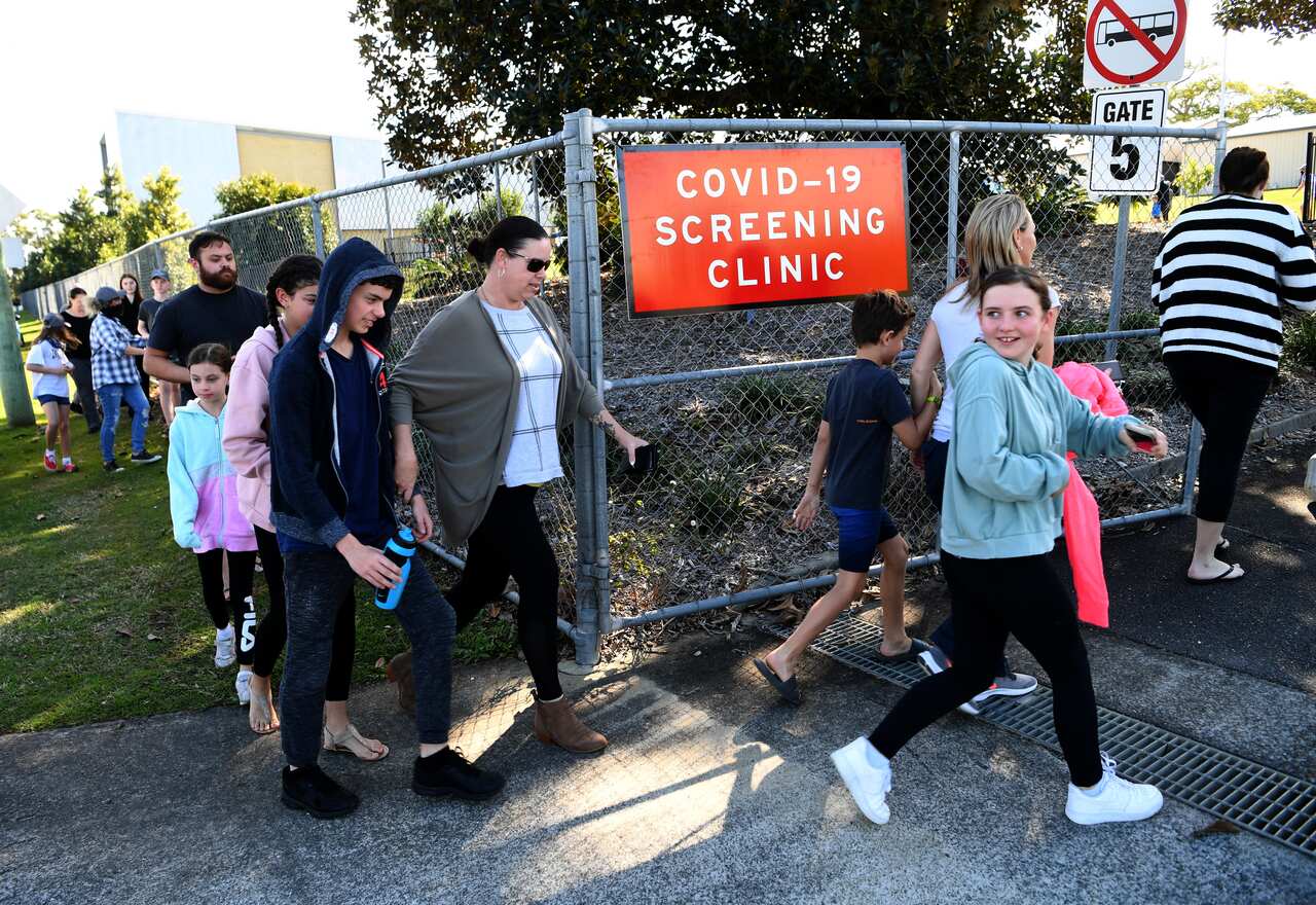 People arrive to get COVID-19 tested at the Parklands Christian College in Logan, south of Brisbane, Wednesday, July 29, 2020. The school has been temporarily closed after an employee tested positive for COVID-19. (AAP Image/Dan Peled) NO ARCHIVING