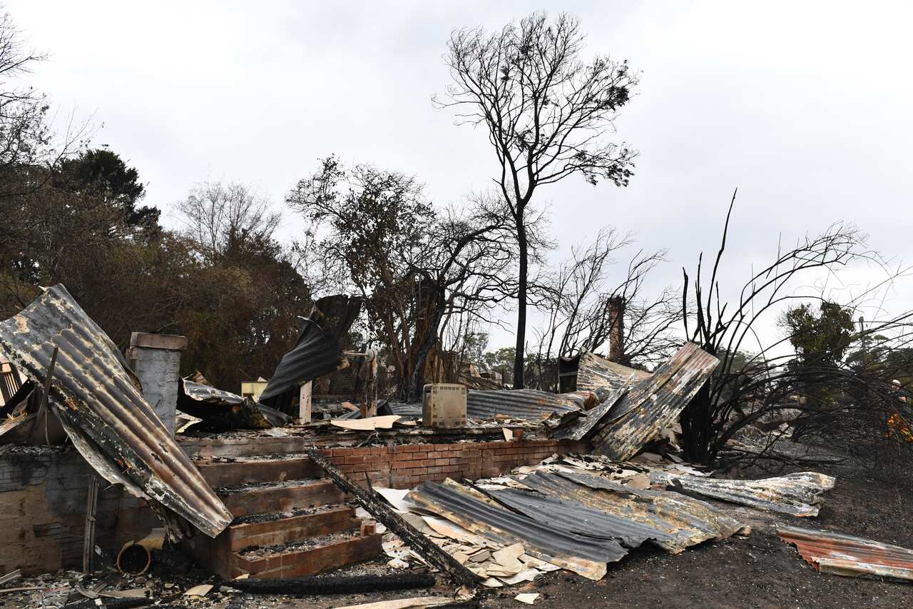 The burnt out remains of a house is seen from a bushfire in the Southern Highlands town of Wingello, 160km south west of Sydney.