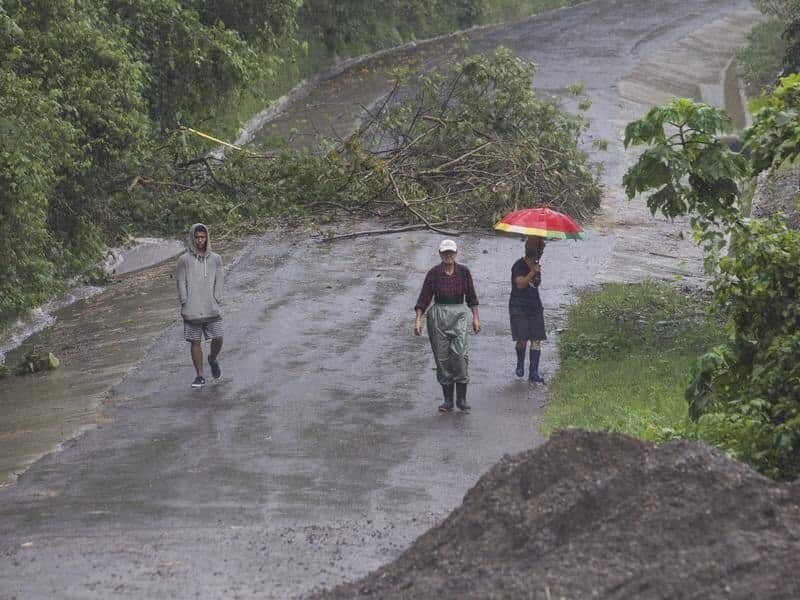 Neighbours walk under the rain