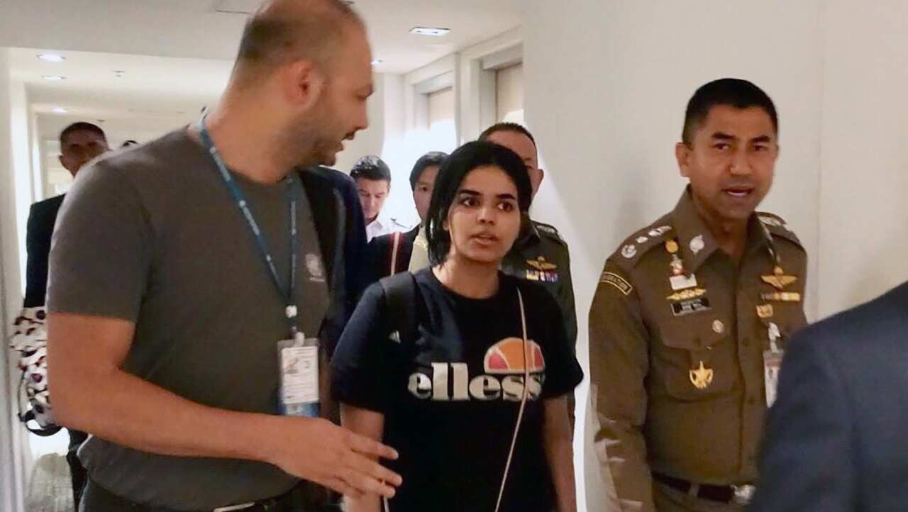 Rahaf Mohammed al-Qunun chats with Thai Immigration Police Chief Surachet Hakparn and an unidentified UNHCR officer at the Suvarnabhumi international airport.