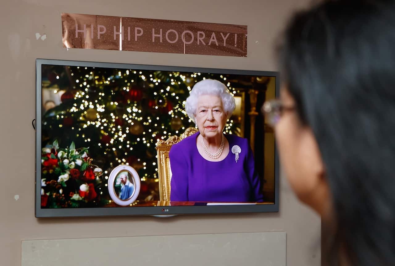 A woman watches the Queen Elizabeth II's speech from her home in Leeds. 