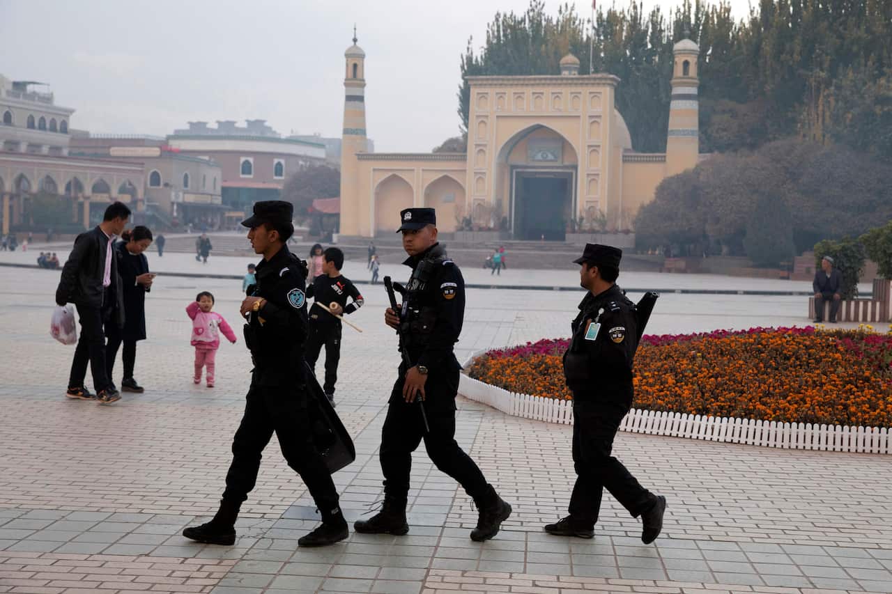 Uighur security personnel patrol near the Id Kah Mosque in Kashgar in western China's Xinjiang region in 2017.