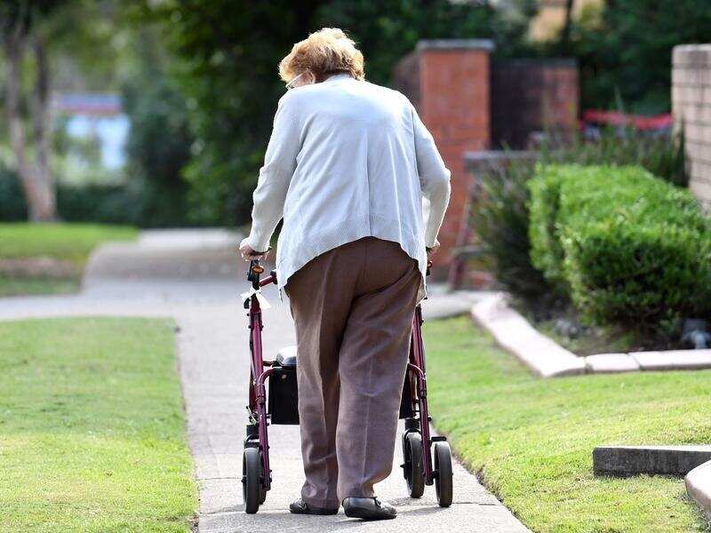 An elderly woman uses a mobility walker in Sydney (file image)