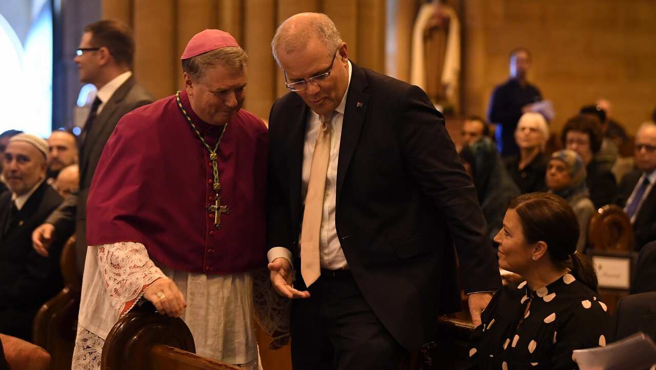 Archbishop of Sydney Anthony Fisher (left) greets Prime Minister Scott Morrison and wife Jenny Morrison during an Interfaith gathering at St Mary's Cathedral.