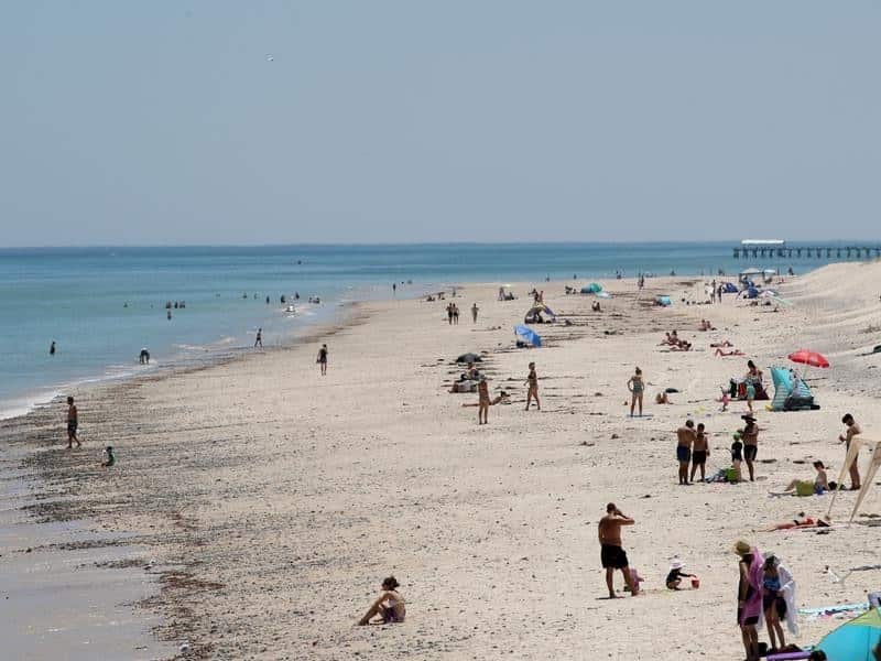 Beach goers cool off at West Beach in Adelaide.