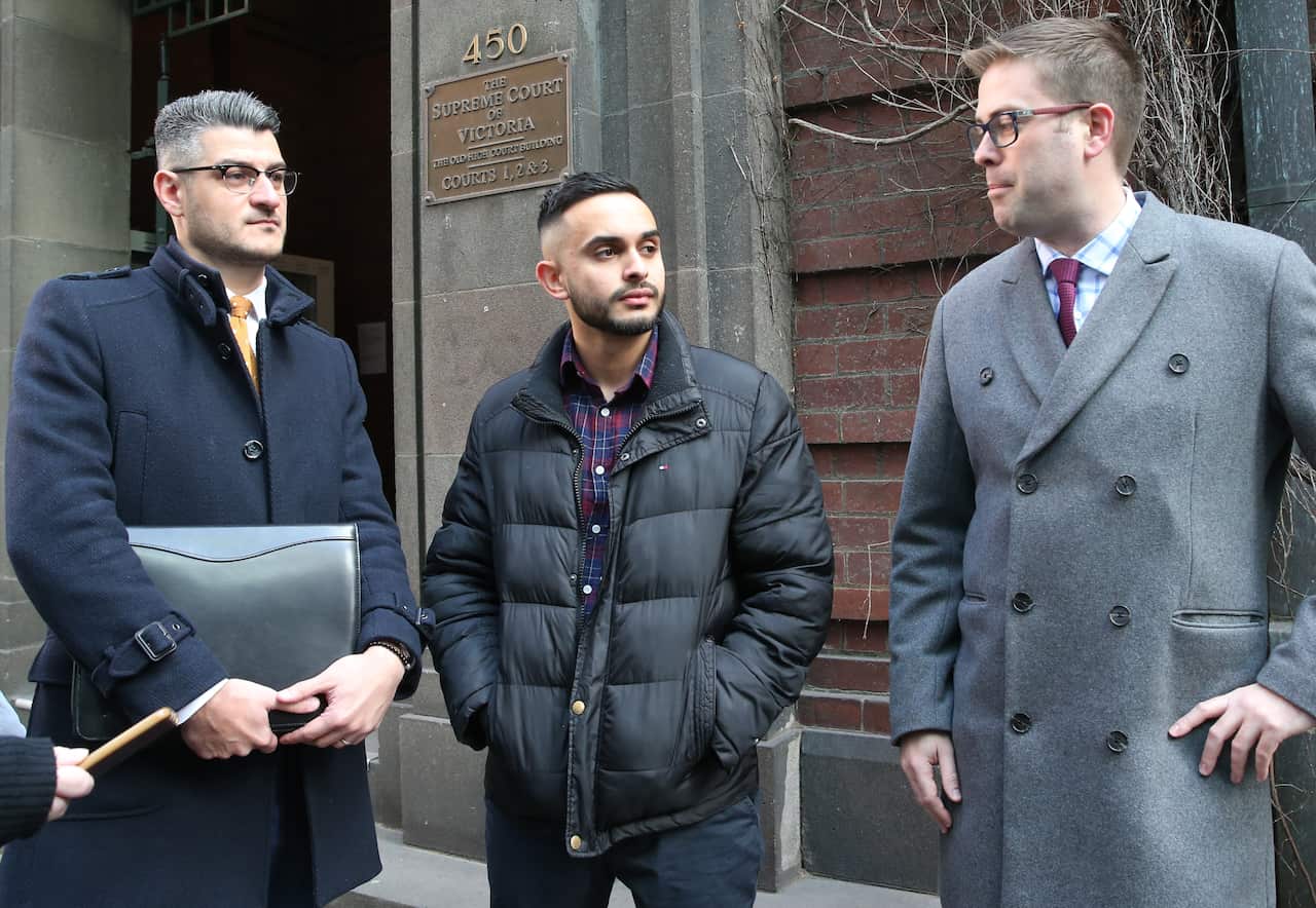 Eathan Cruse (centre) leaves the Victorian Supreme Court in Melbourne.